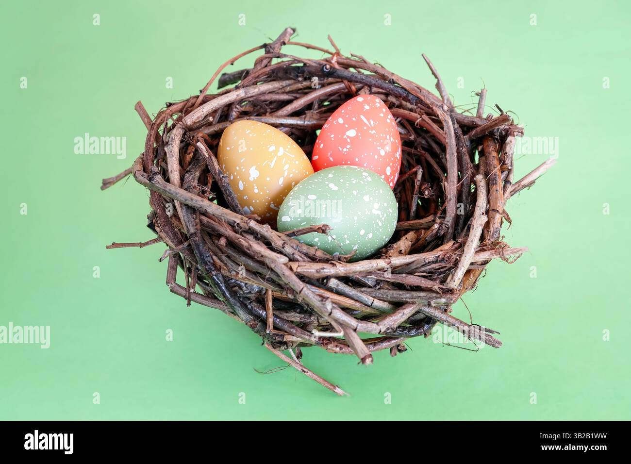 Three speckled eggs in bird's nest over green background Stock Photo ...