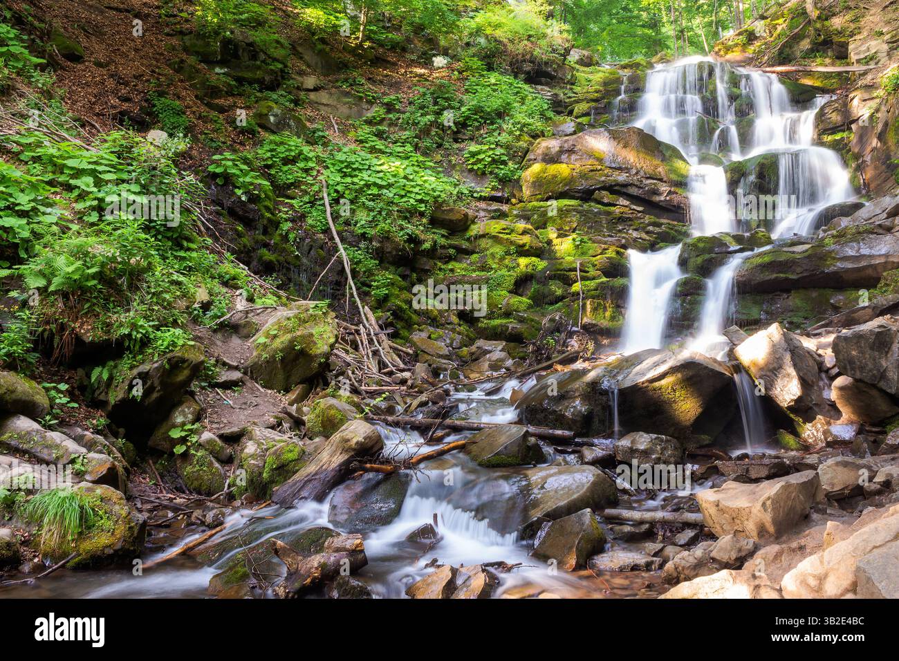 waterfall shypit of carpathian mountains in summer. scenic view. scenery in morning light. popular travel destination of ukraine. ecology day backgrou Stock Photo