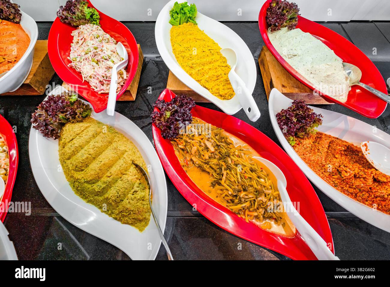 various salads and hummus on buffet table Stock Photo