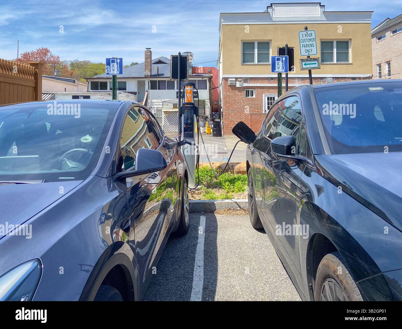 Electric car plugged in at ChargePoint EV charging station in suburban Chappaqua, Westchester County, New York, an EV-friendly town, April 23, 2025. - Smartphone Captured Stock Image