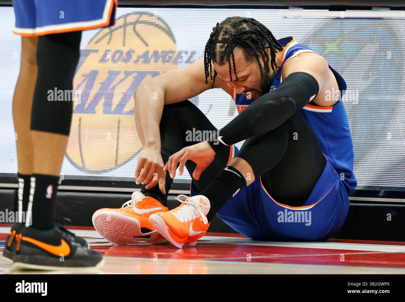 New York Knicks guard Jalen Brunson (11) sits against the scorers table ...