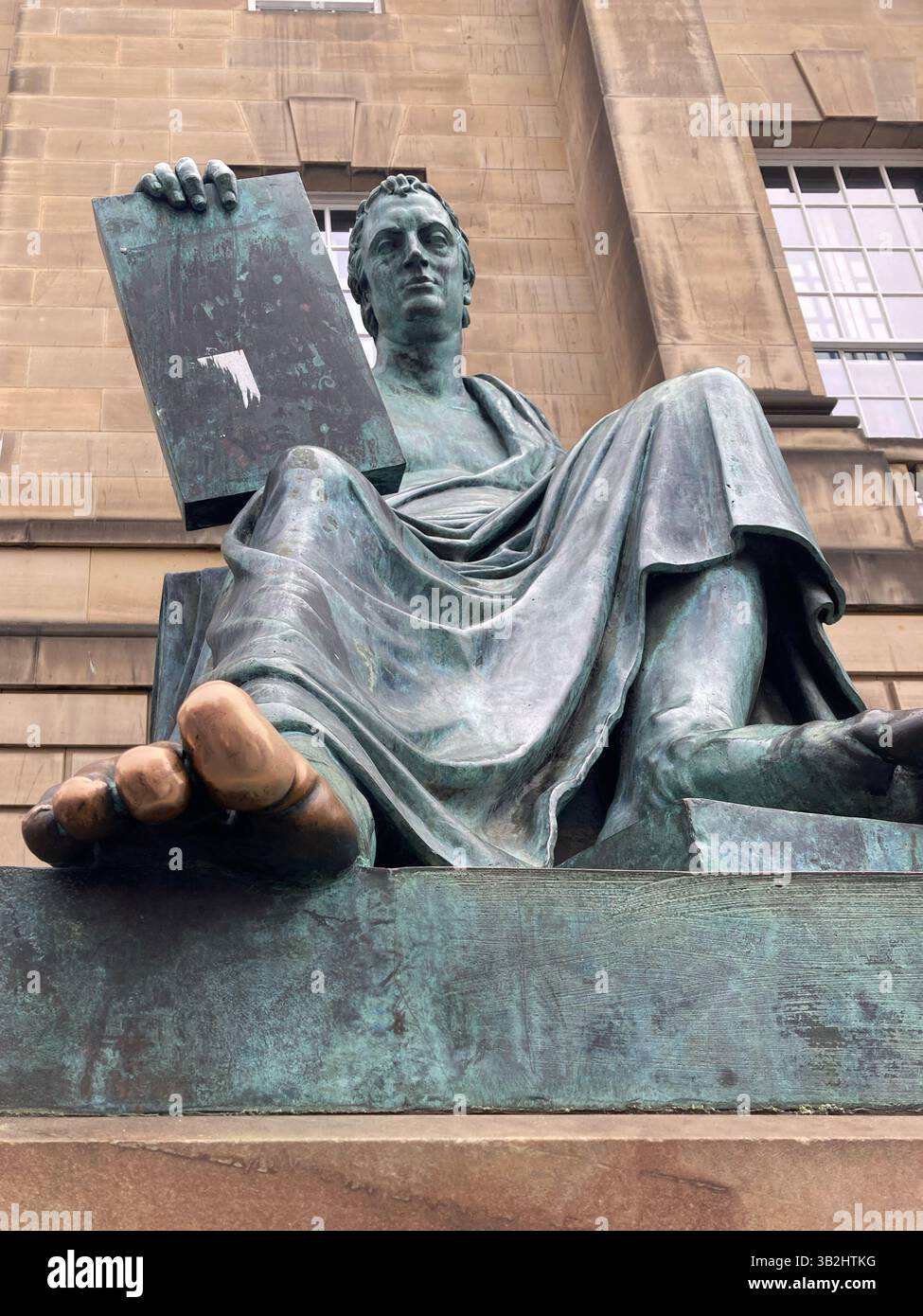 The David Hume statue with his shiny toe after being endlessly rubbed by tourists for good luck, Royal Mile, Edinburgh Scotland Stock Photo