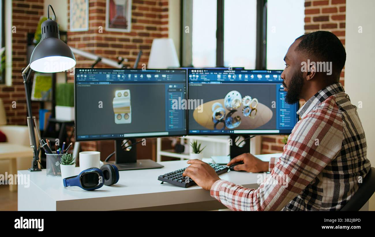 Engineer designs a turbine in an industrial office using CAD software ...