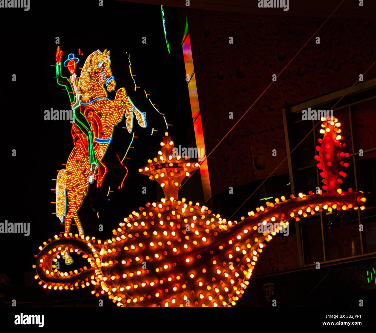 Illuminated Horse and Caballero with Aladdin's Lamp Neon Signs at The Entrance to Freemont East, Las Vegas, Nevada, USA Stock Photo