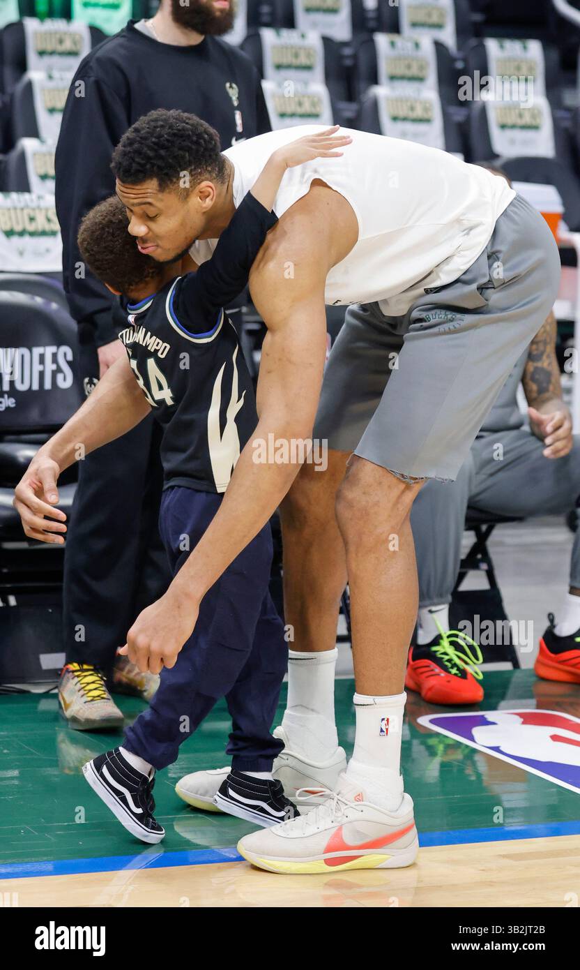 Milwaukee Bucks forward Giannis Antetokounmpo gets a hug from his son
