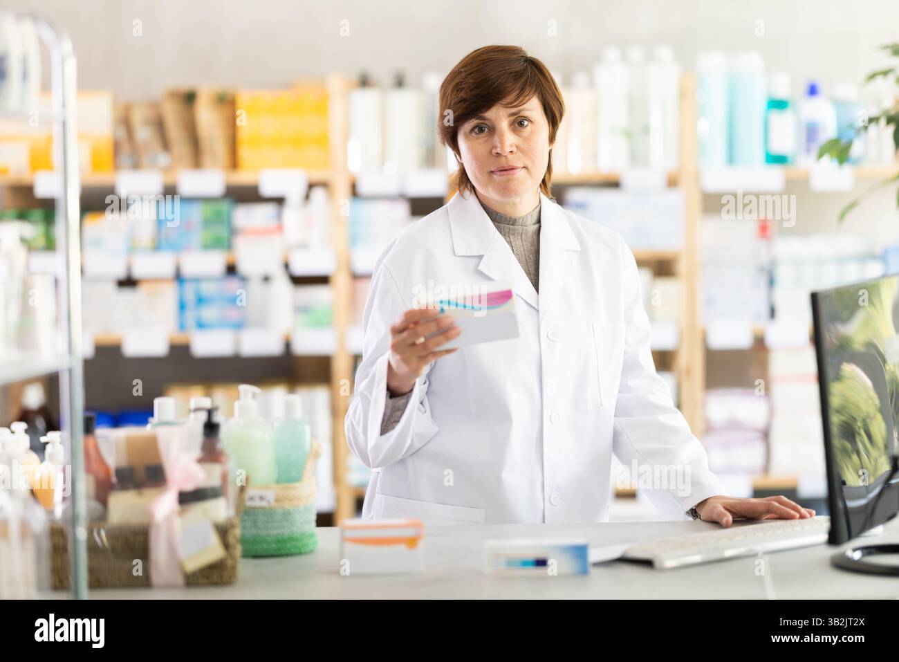 Female pharmacist checking medication details before offering to ...