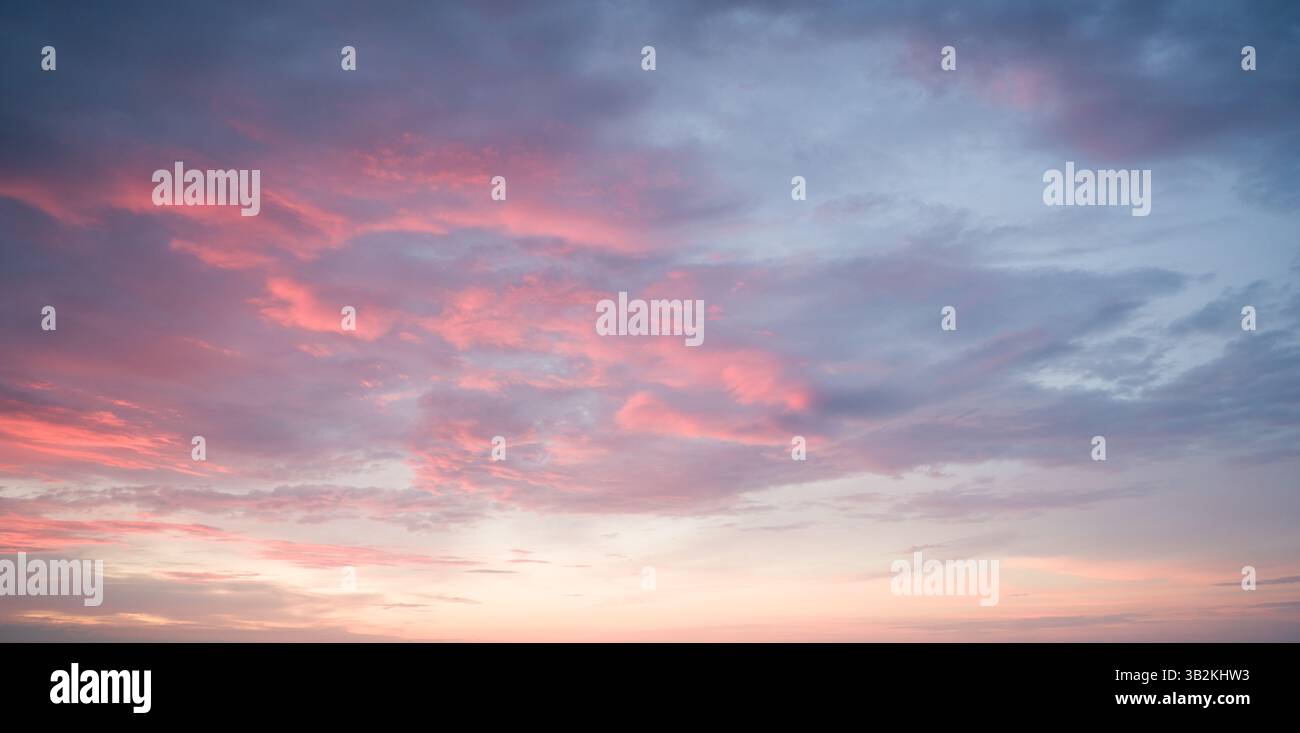 Pink Clouds at Sunset: Sky Beauty. Stock Photo