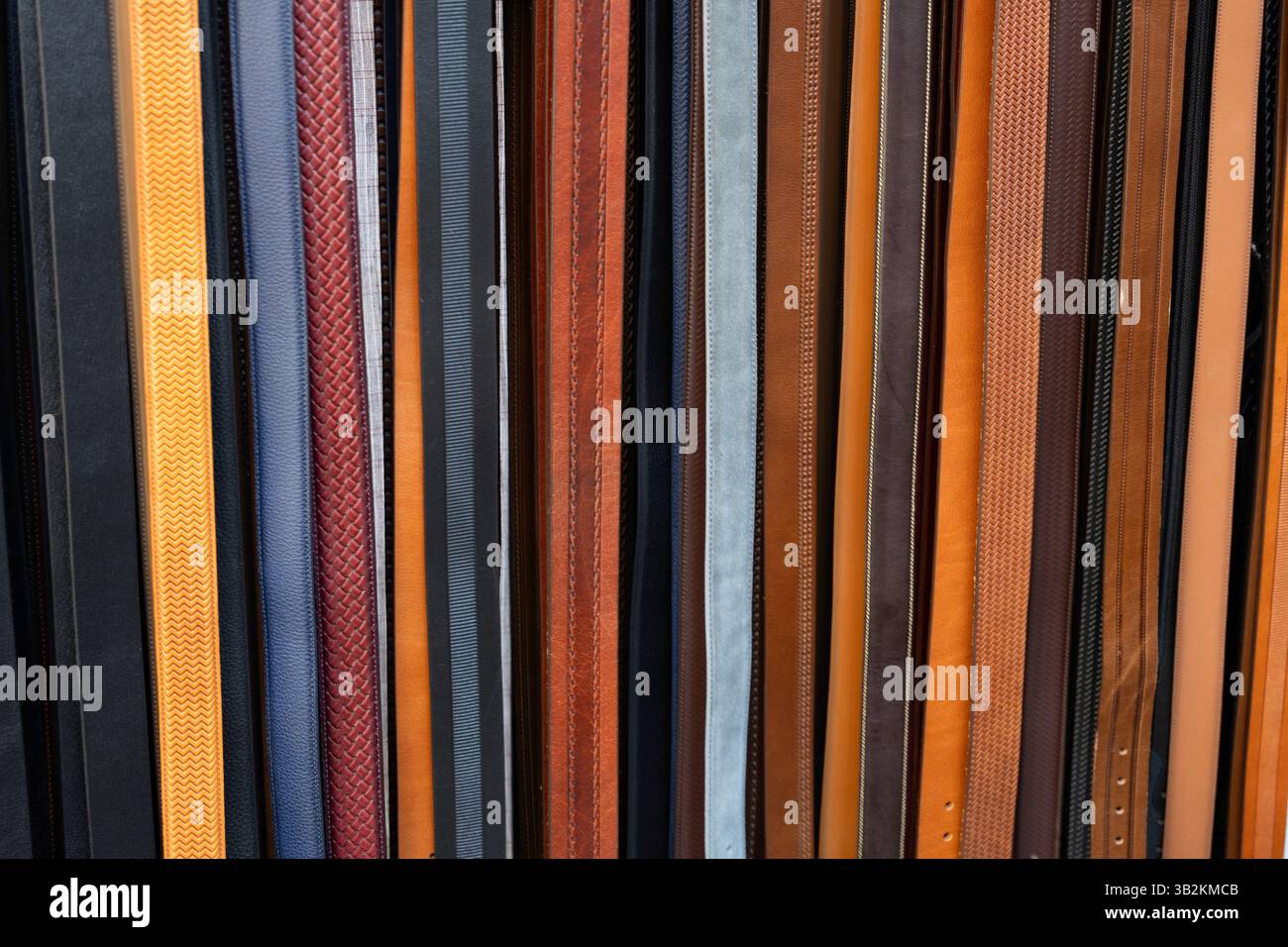 Colourful leather belts for use as a background texture Stock Photo