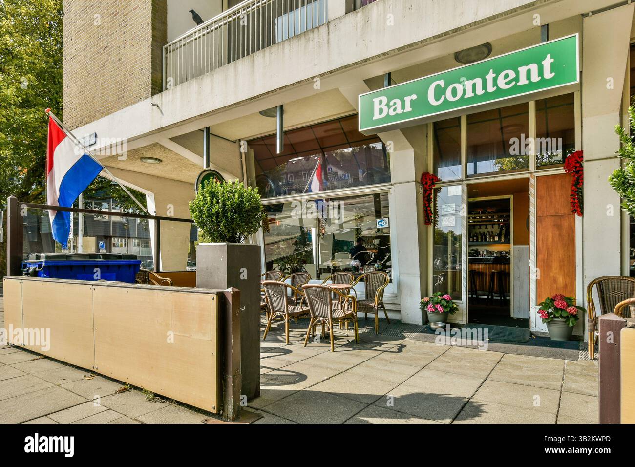 An inviting bar exterior featuring outdoor seating, decorative plants ...
