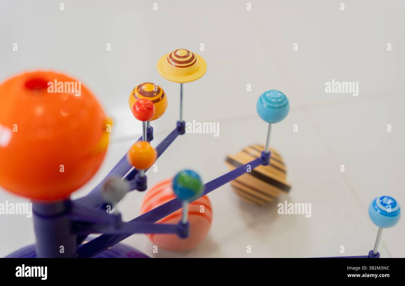 Solar system model toy planets for kid on the floor  with blank space for text. Selective focus, copy space. Stock Photo