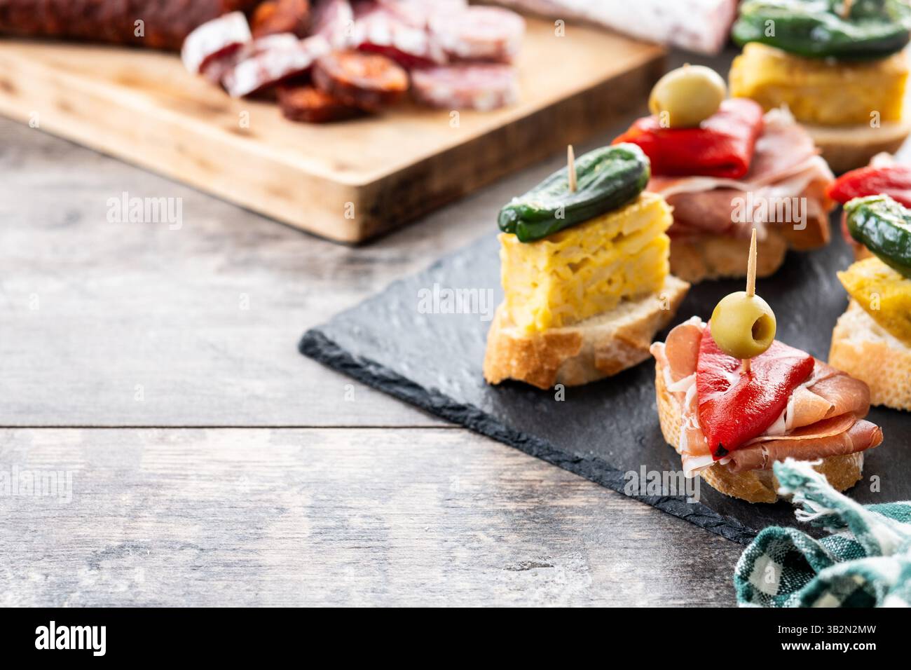Traditional Spanish pintxos on wooden table Stock Photo