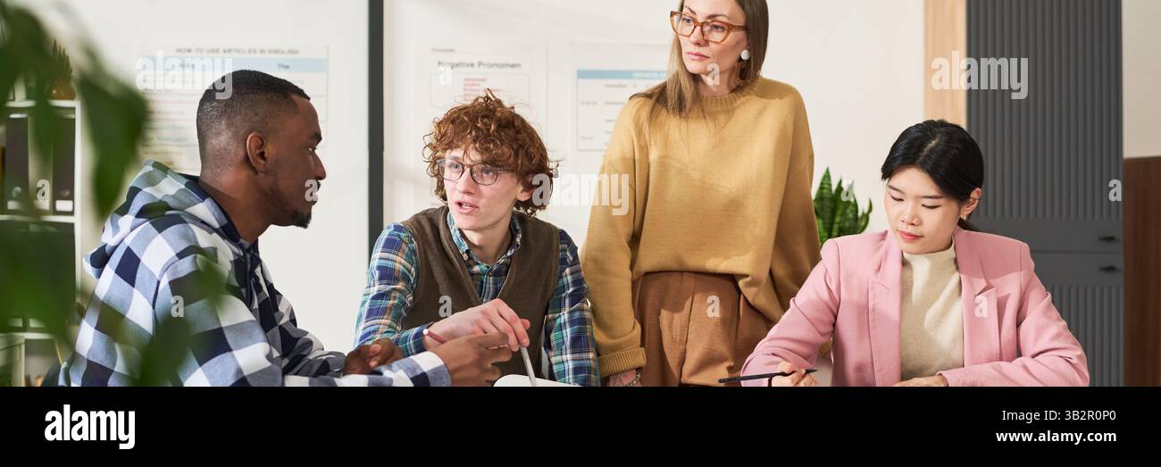 Studying Foreign Languages with Teacher in Classroom Setting Stock Photo