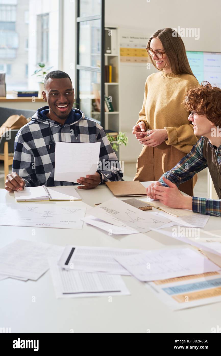 Discussing Foreign Language Projects in Classroom Setting Stock Photo