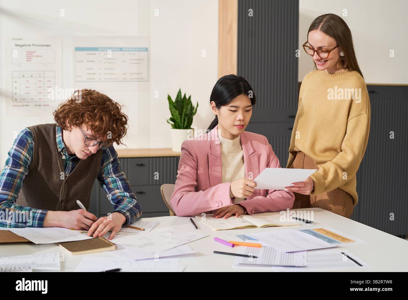 Studying Foreign Languages in Modern Classroom Setting Stock Photo