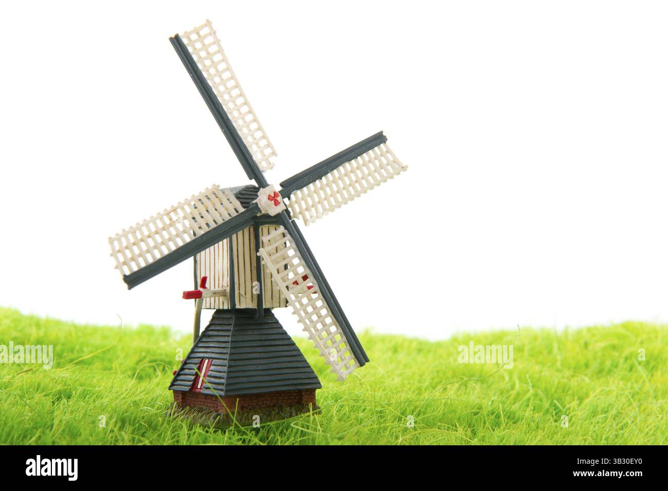 Plastic dutch in grass windmill isolated over white background Stock ...