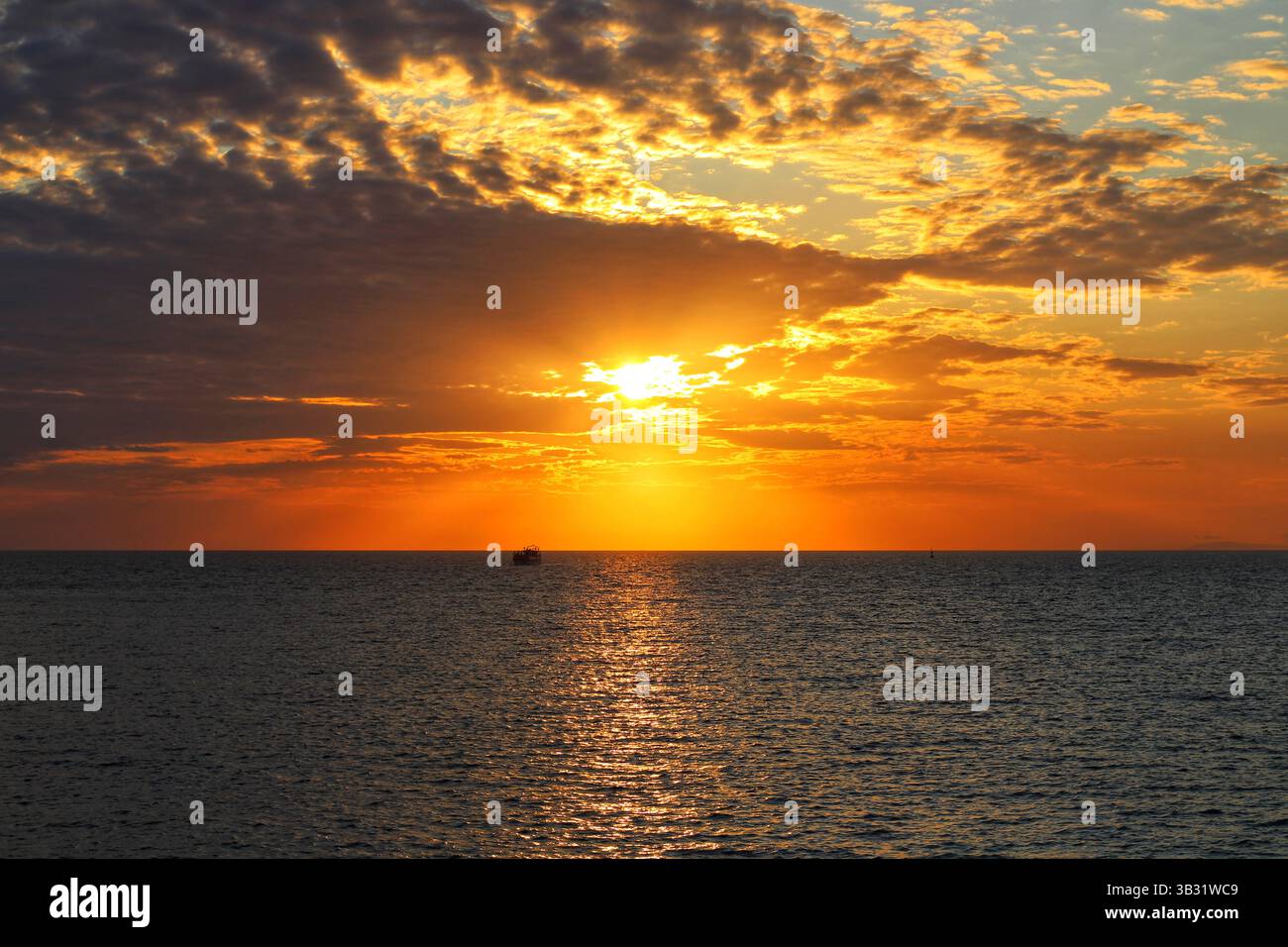 Sunset over boat on sea hi-res stock photography and images - Alamy