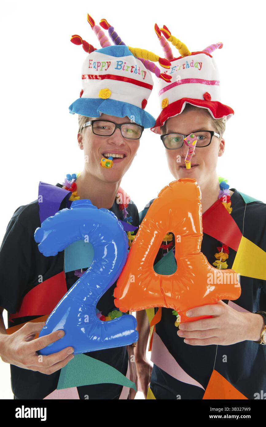 Identically adult male twins having birthday in studio Stock Photo - Alamy