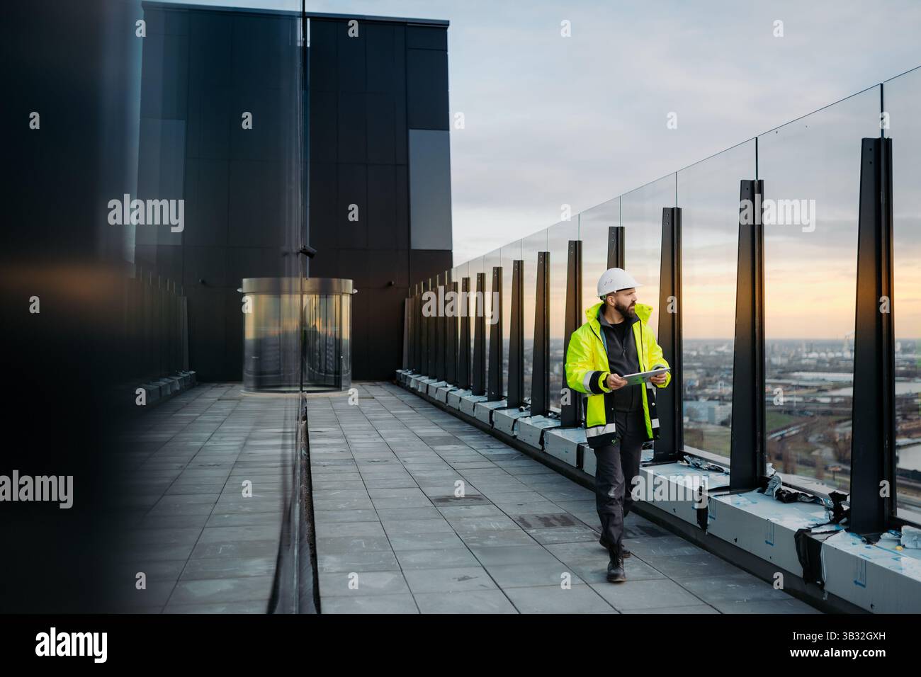 Construction site manager using digital tablet to inspect building progress. Stock Photo