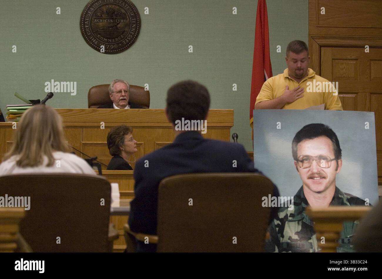 September 17, 2007 - Kingston, TN, USA - HYATTE8.JH#8414.jpg Dennis Morgan stands behind a picture of this father Tennessee Corrections officer Wayne Cotton Morgan who was slain in front of the Roane County Courthouse during a prison escape. Dennis Morgan is seen here addressing Jennifer Hyatte who plead guilty to shooting the corrections officer.  photo by Joe Howell (Credit Image: © Joe Howell/Knoxville News Sentinel via ZUMA Wire) Stock Photo