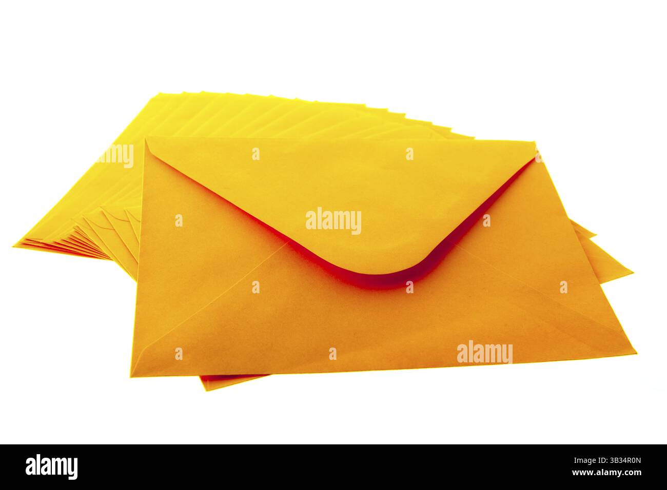 Stacked orange envelopes isolated over white background Stock Photo
