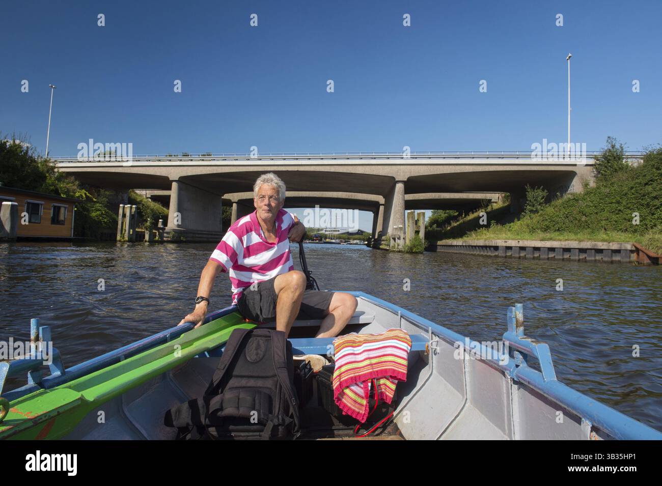 Elderly man in boat at the river Stock Photo - Alamy