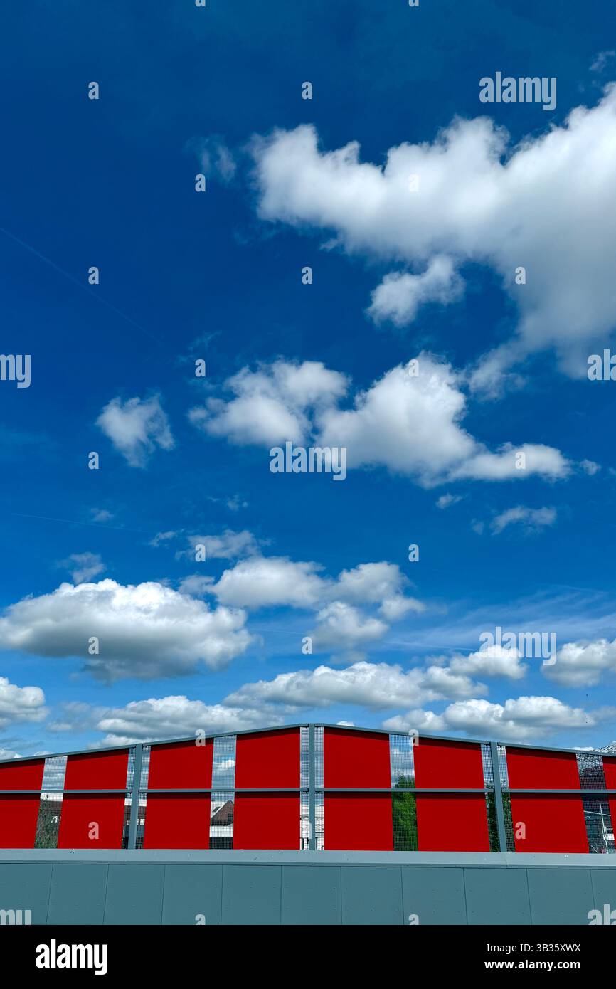Red chevrons pointing to a blue sky full of clouds on bridge over Bridgewater canal at Old Trafford, Manchester - Smartphone Captured Stock Image