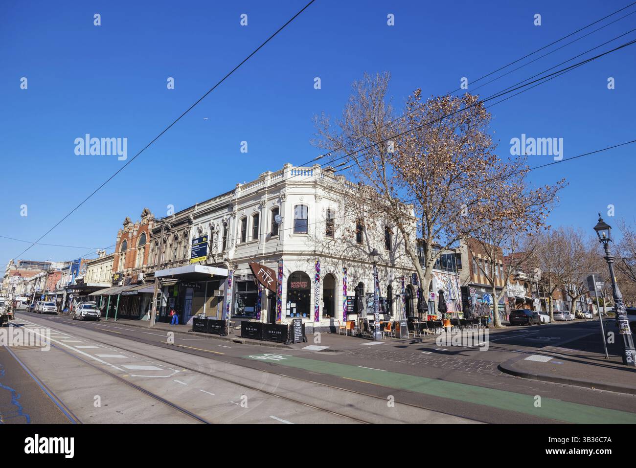 MELBOURNE, AUSTRALIA - AUGUST 01, 2024: The famous and popular shopping street of Brunswick St and The Fitz Cafe on a warm winter's day in Fitzroy, Vi Stock Photo