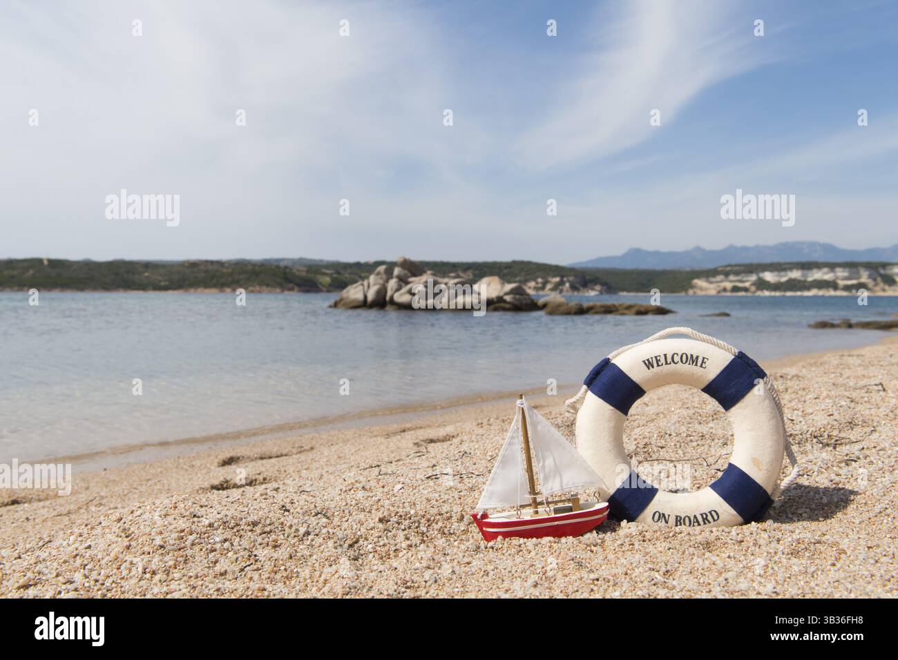 Corsica beach landscape east coast with life buoy and miniature sail boat Stock Photo