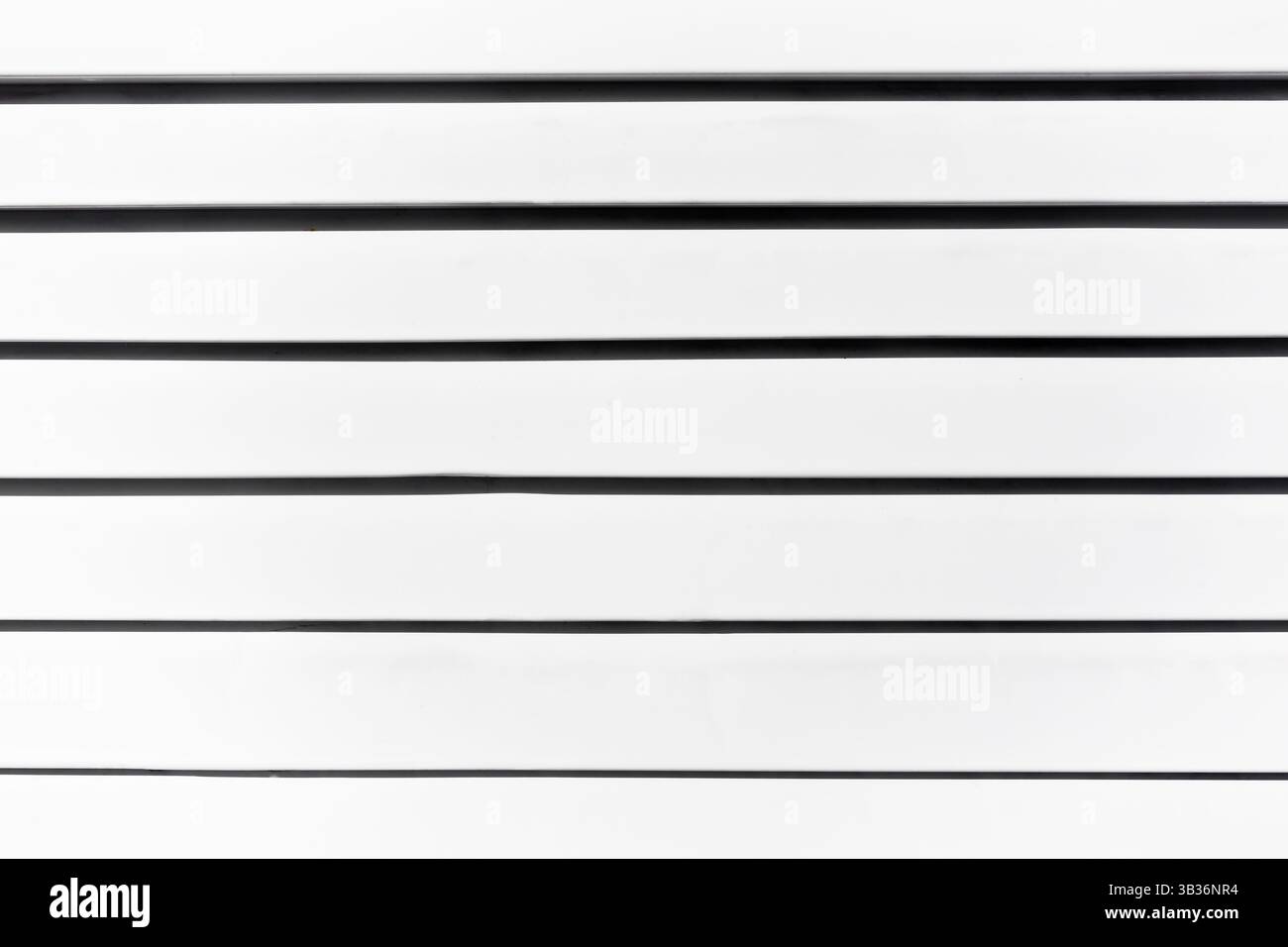 White covered blinds with black shadows, close-up. Stock Photo