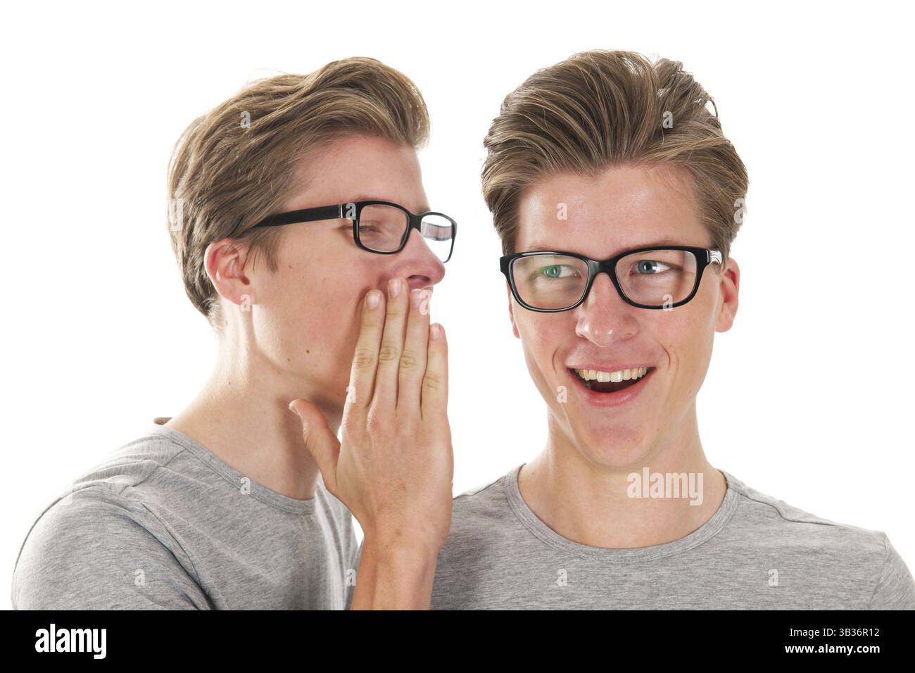 Identically adult male twins whispering in ear isolated over white ...
