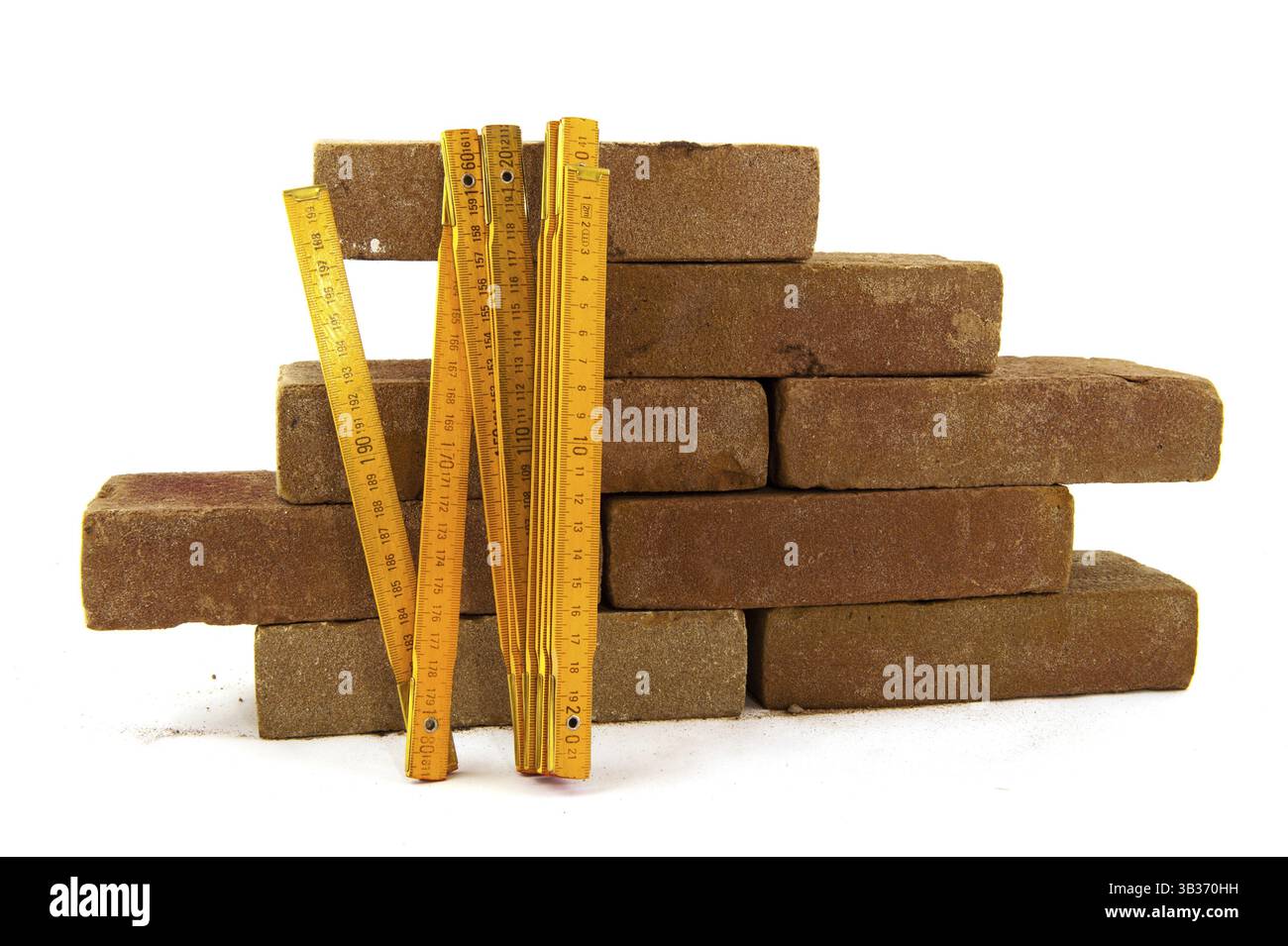Bricks and measuring tool to build a wall or making pavement Stock Photo