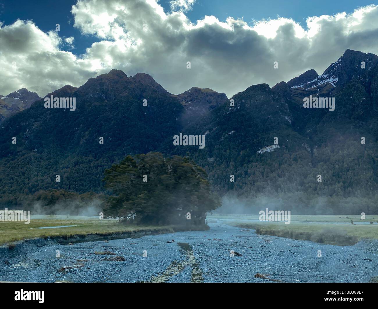 View over mountain ranges near Milford Sound with steam rising from ...