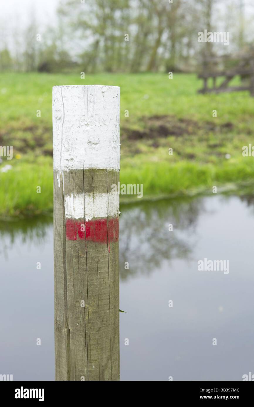 Walking route mark on a pole in nature environment Stock Photo - Alamy