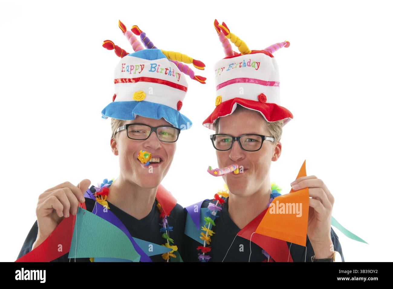 Identically adult male twins having birthday in studio Stock Photo - Alamy