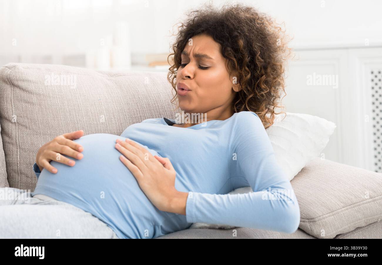 Expectant woman having contractions and doing breathing exercises Stock ...