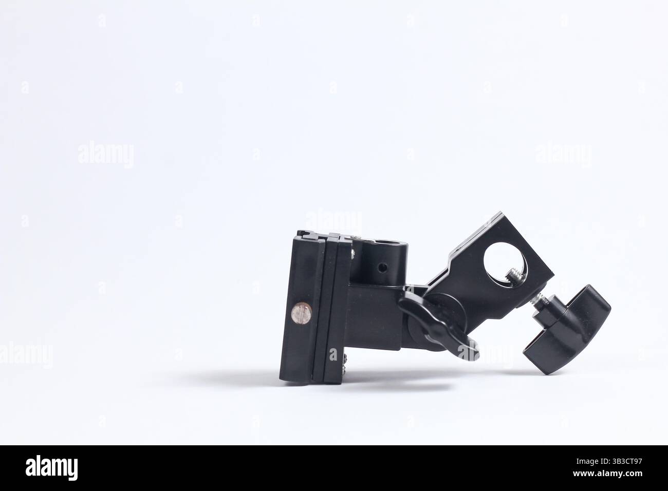 flash holder tripod mount for external flash and white umbrella for studio shooting Stock Photo
