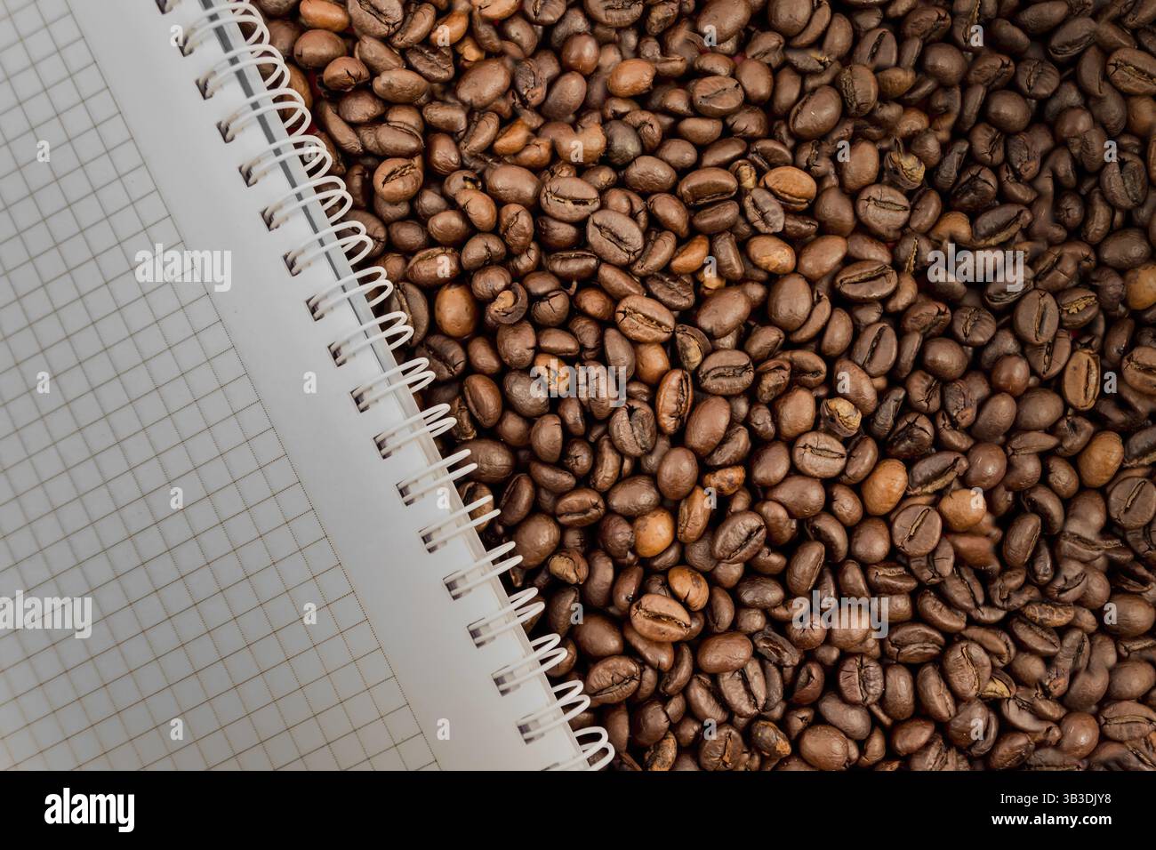 Full frame of coffee beans also with empty notebook Stock Photo
