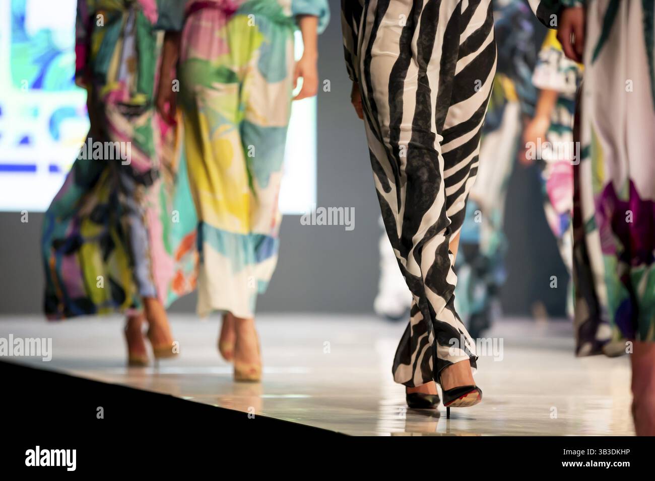 Female models walk the runway in beautiful colorful summer dresses ...
