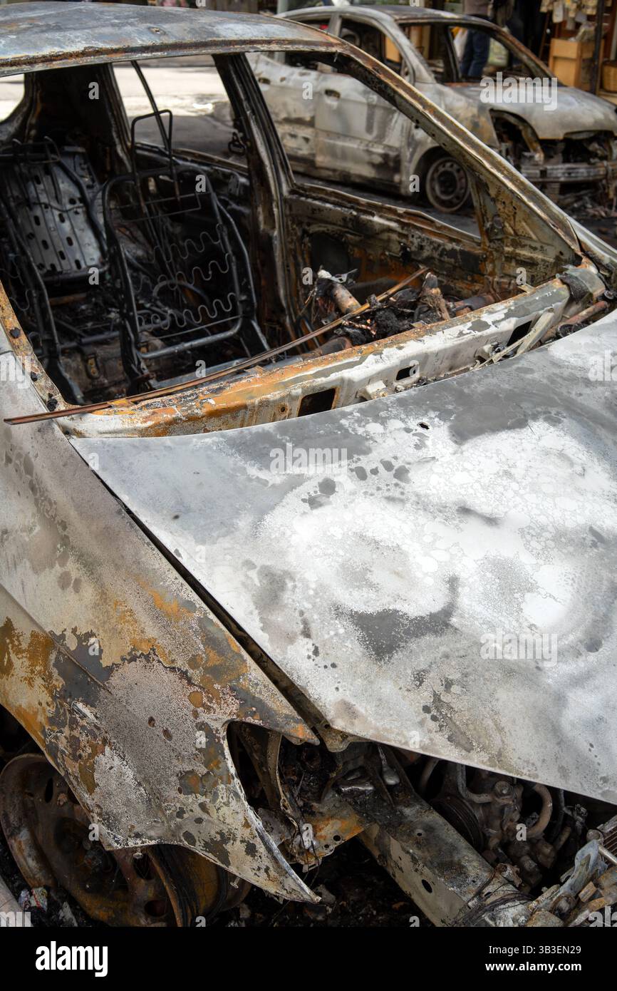 Cars burnt in Eksarchia district after clashed between anarchists and the police. Stock Photo