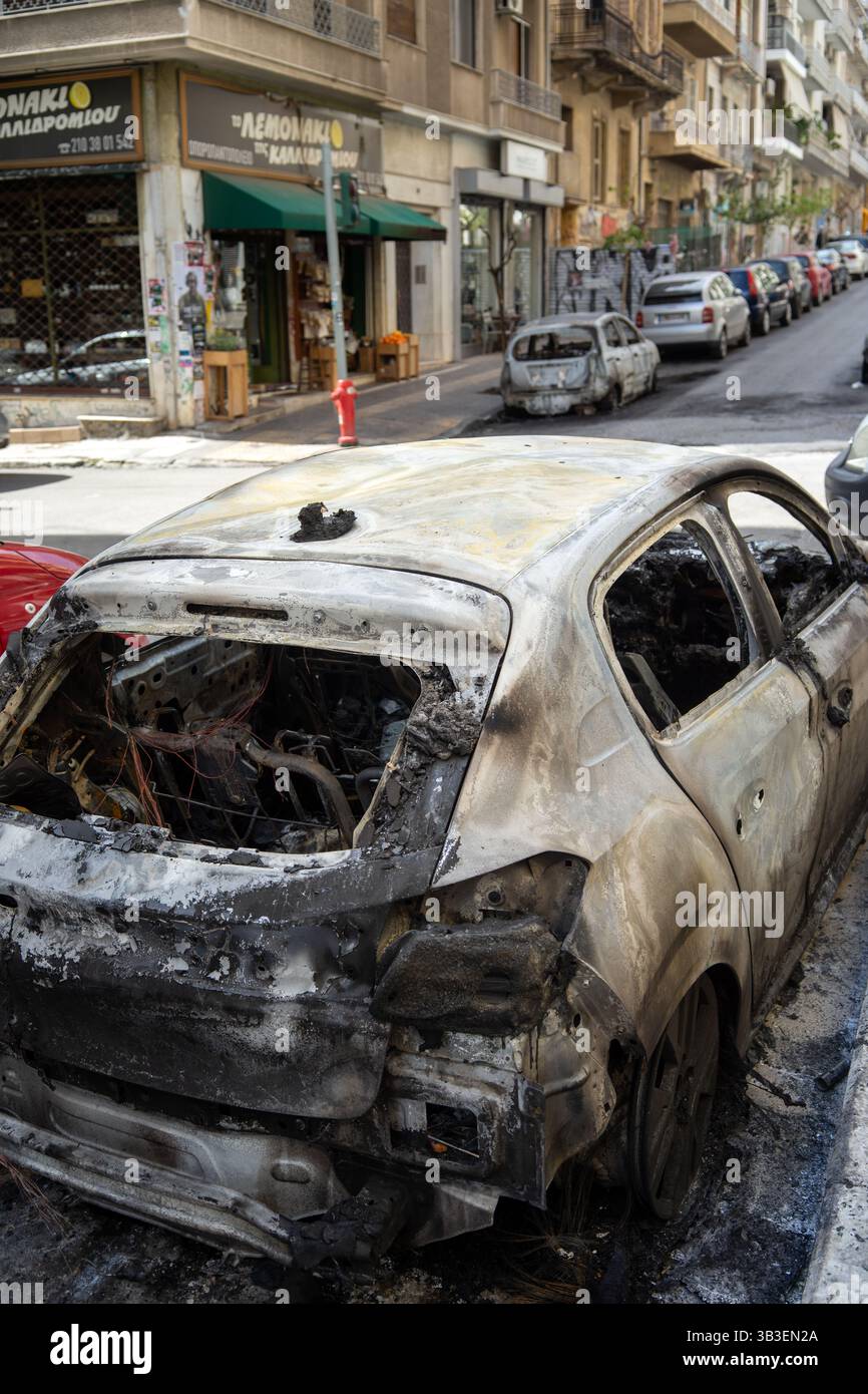 Cars burnt in Eksarchia district after clashed between anarchists and the police. Stock Photo