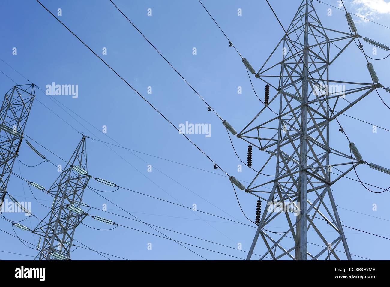 High voltage power lines, wires and racks, against a background of blue ...