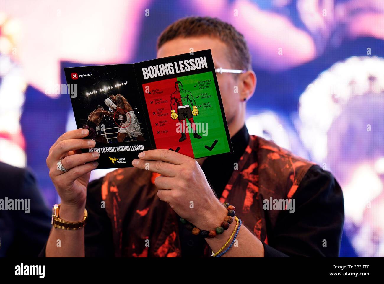 Oleksandr Usyk with a Boxing Lesson leaflet during a press conference ...