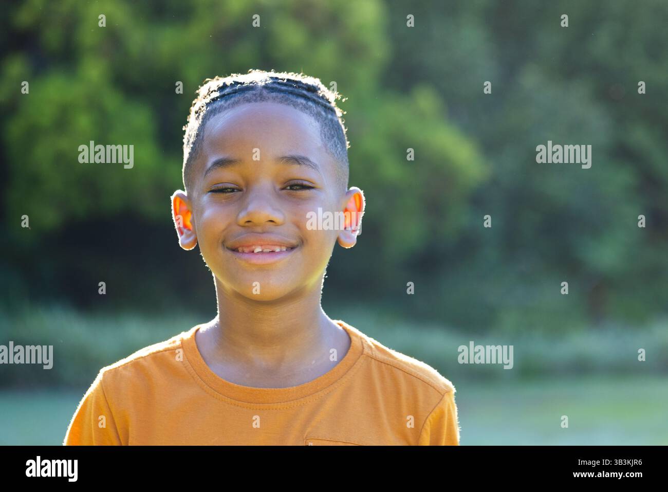 Child in orange shirt hi-res stock photography and images - Alamy