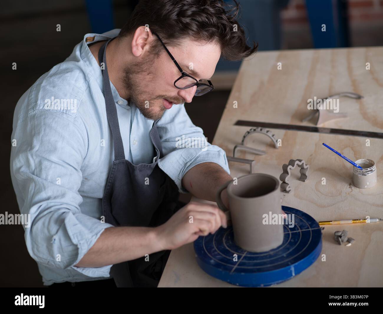 Ceramic artists working in pottery studio Stock Photo - Alamy