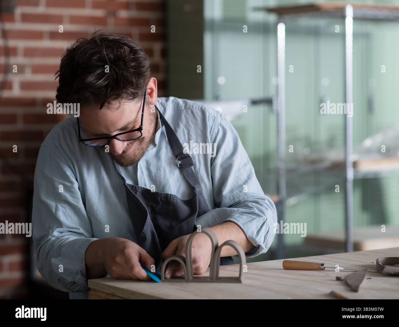 Ceramic artists working in pottery studio Stock Photo - Alamy