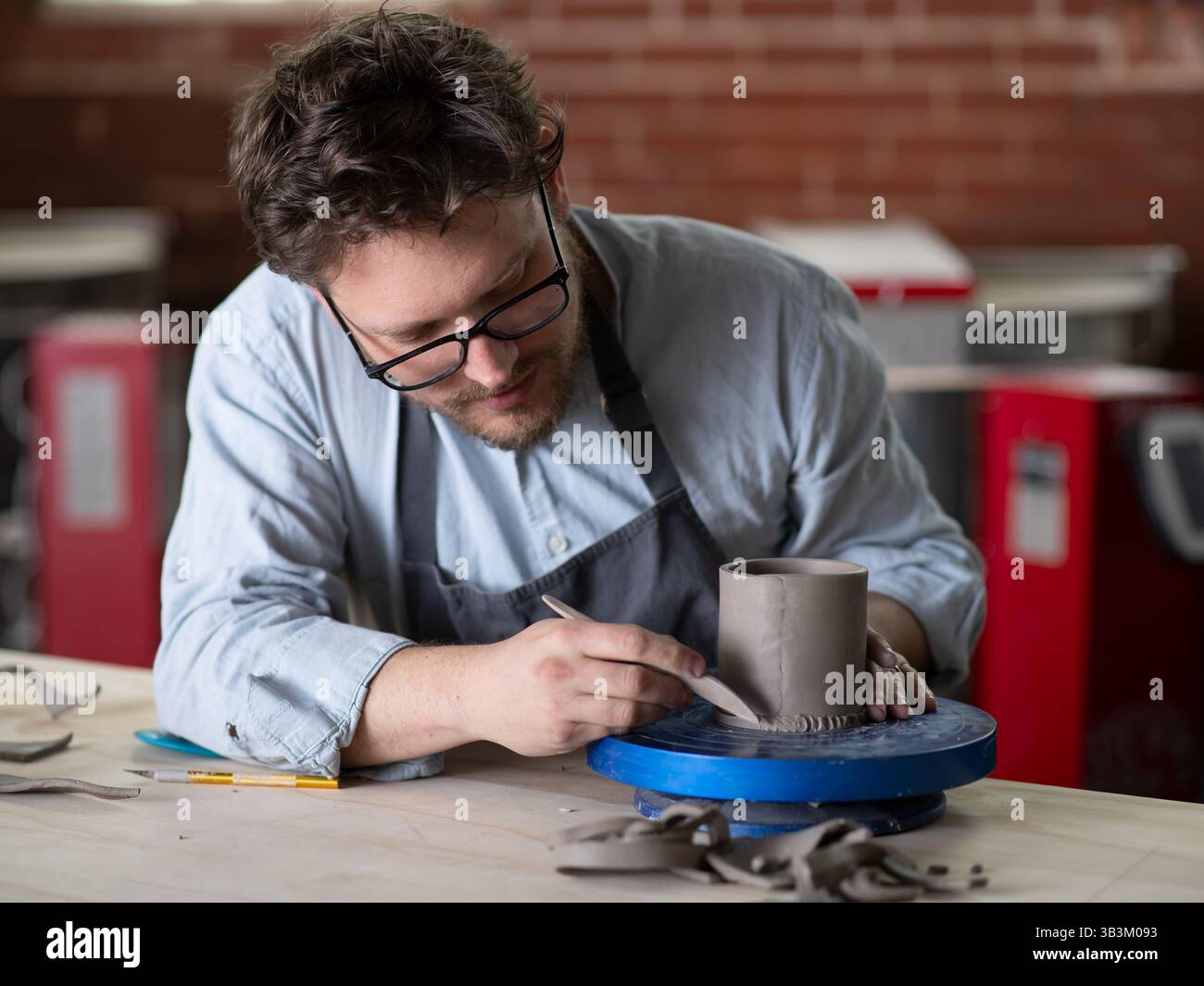 Ceramic artists working in pottery studio Stock Photo - Alamy