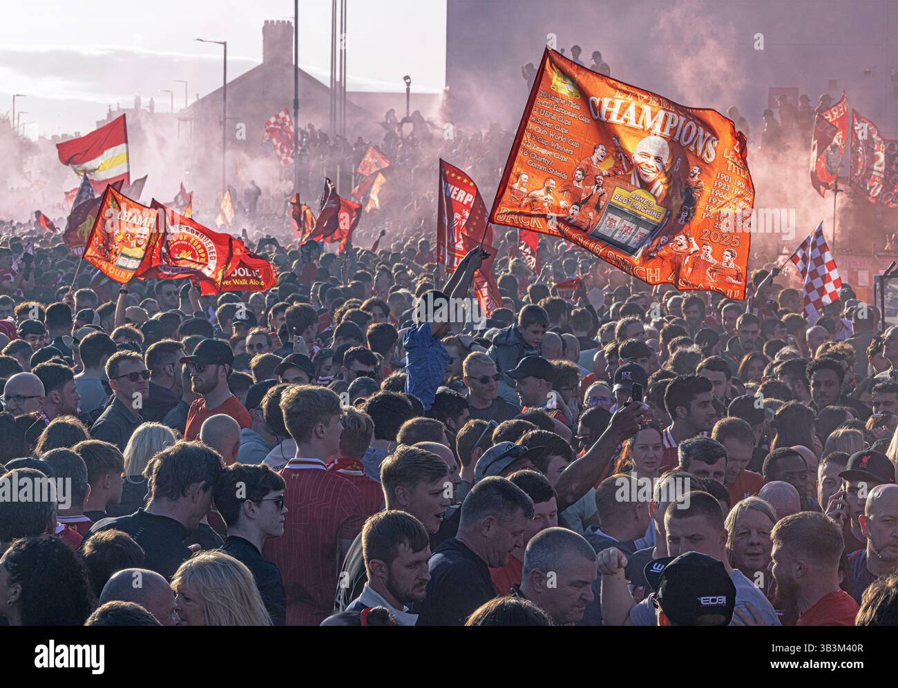 LIVERPOOL, ENGLAND - APRIL 27: Fans of Liverpool set off smoke flares, as they enjoy the pre-match atmosphere outside the stadium prior to the Premier Stock Photo