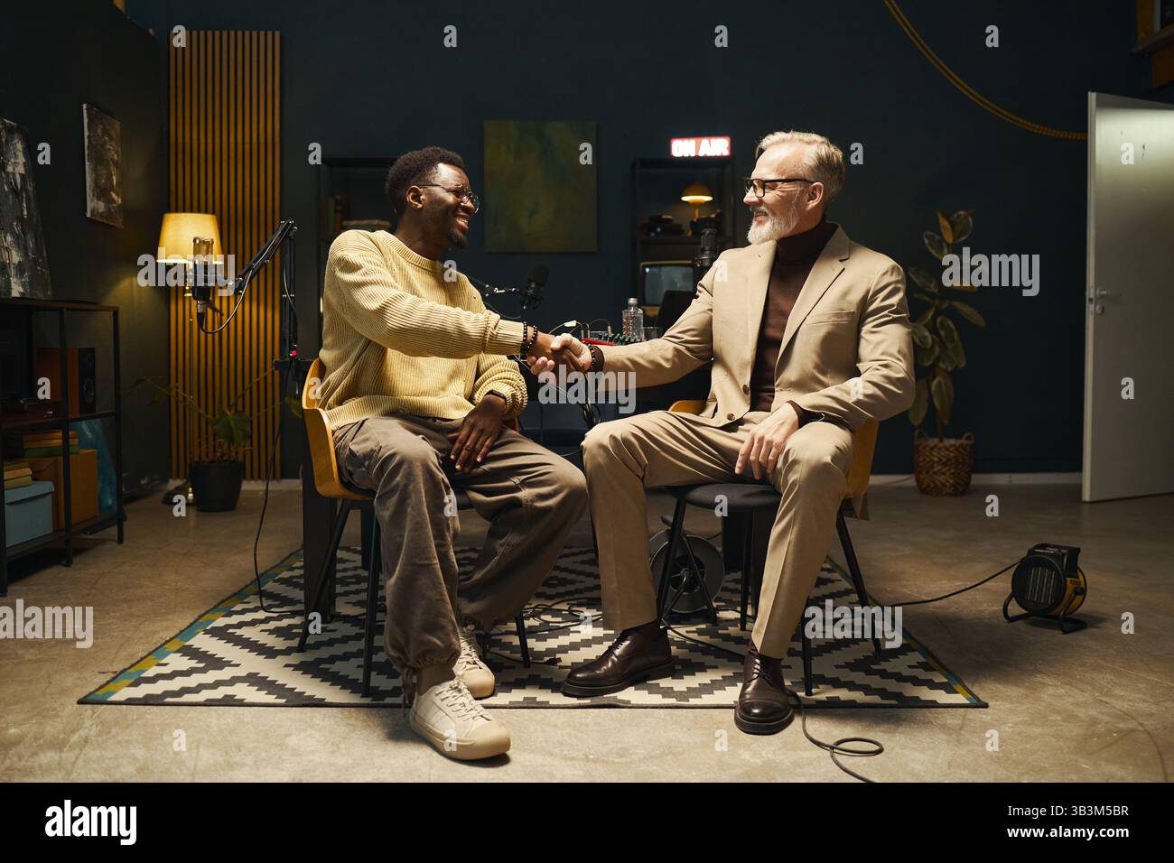 Two Men Greeting Each Other In Recording Studio Stock Photo