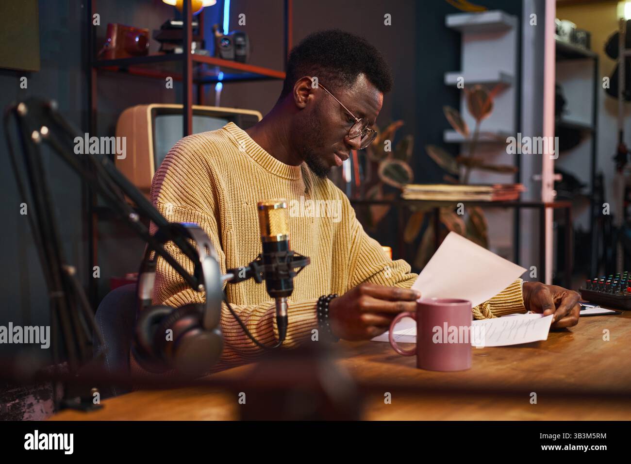 Journalist Reading Content Plan Before Podcast Stock Photo