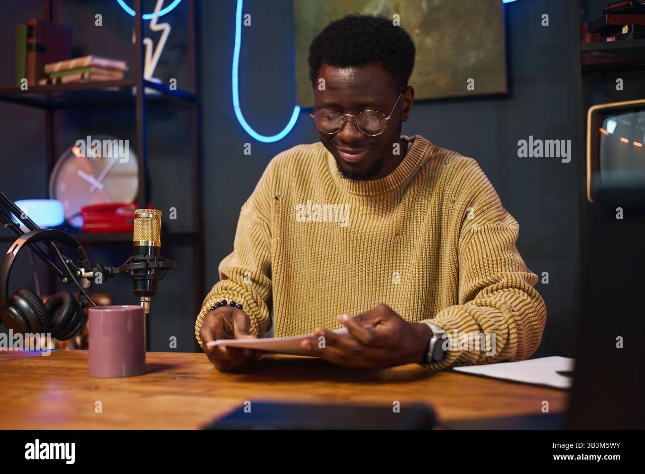 Man Reading Content Plan Before Podcast Stock Photo